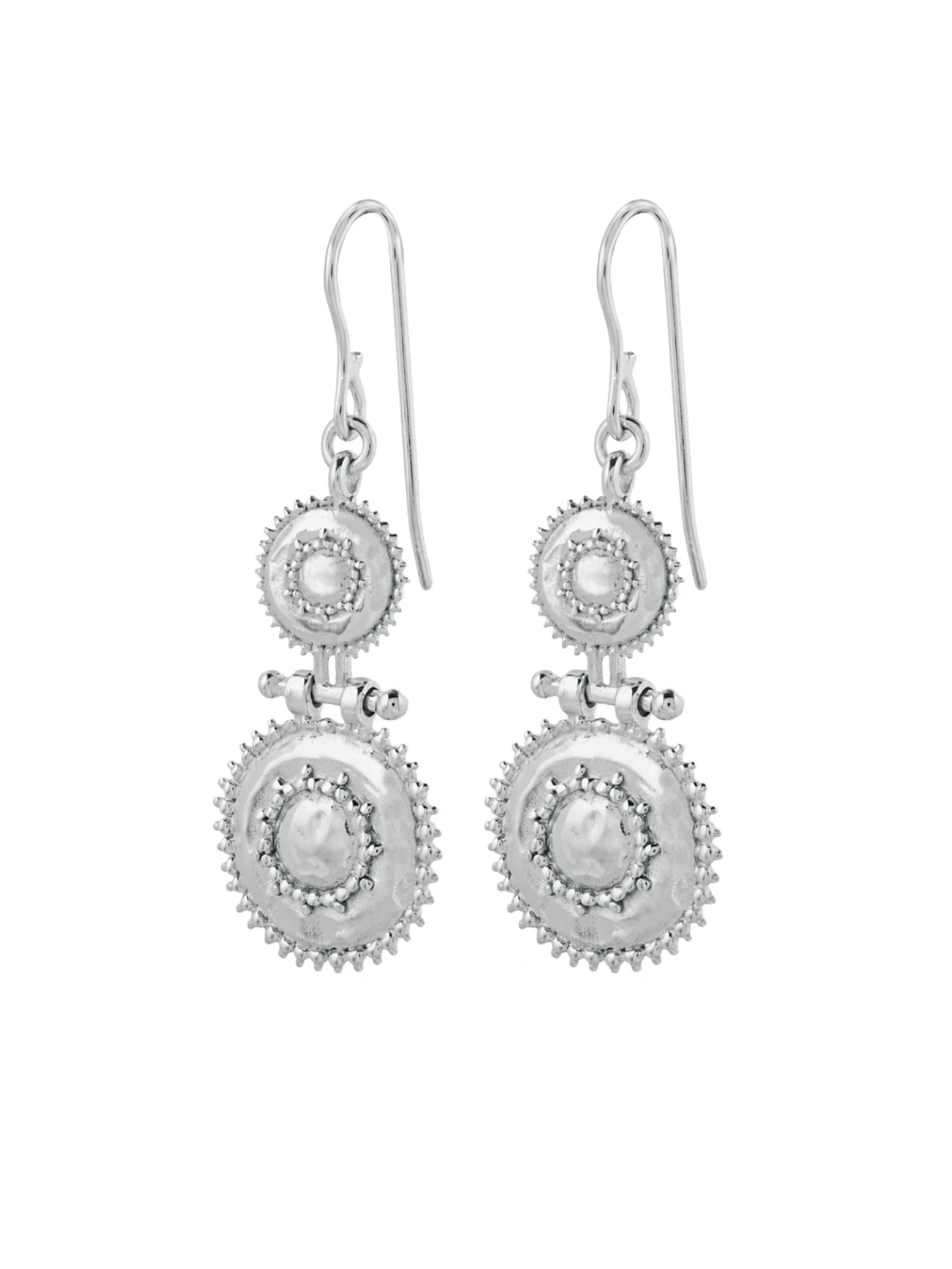 Pair of silver earrings with circular designs on a white background