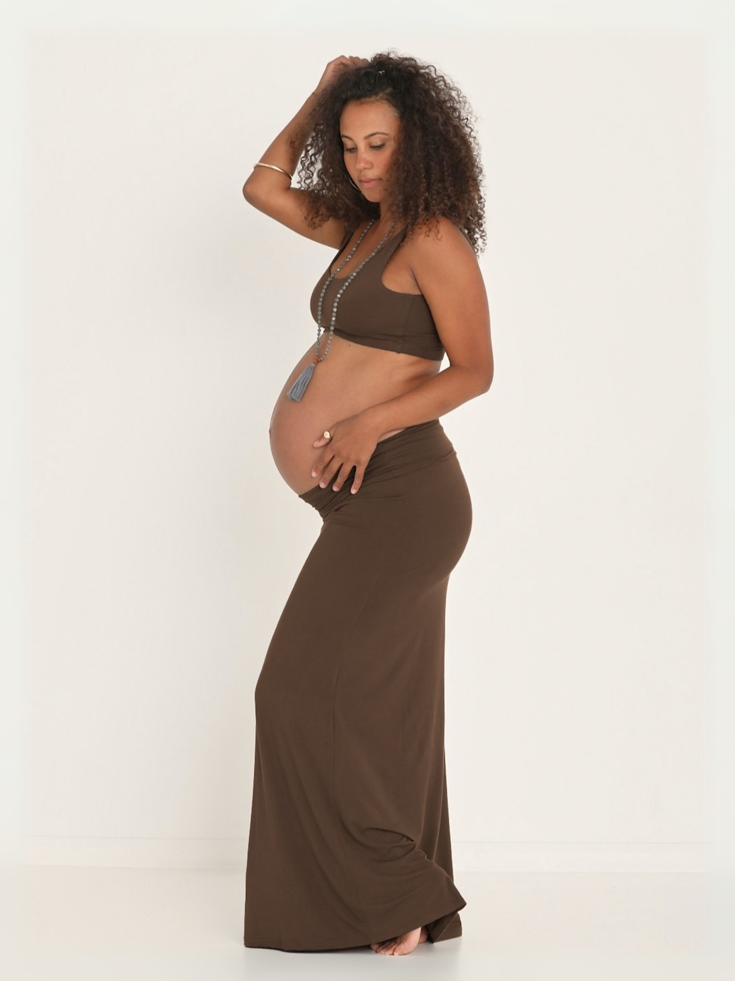 pregnant model wearing a long cocoa brown maxi length skirt and bra, women's bamboo clothing