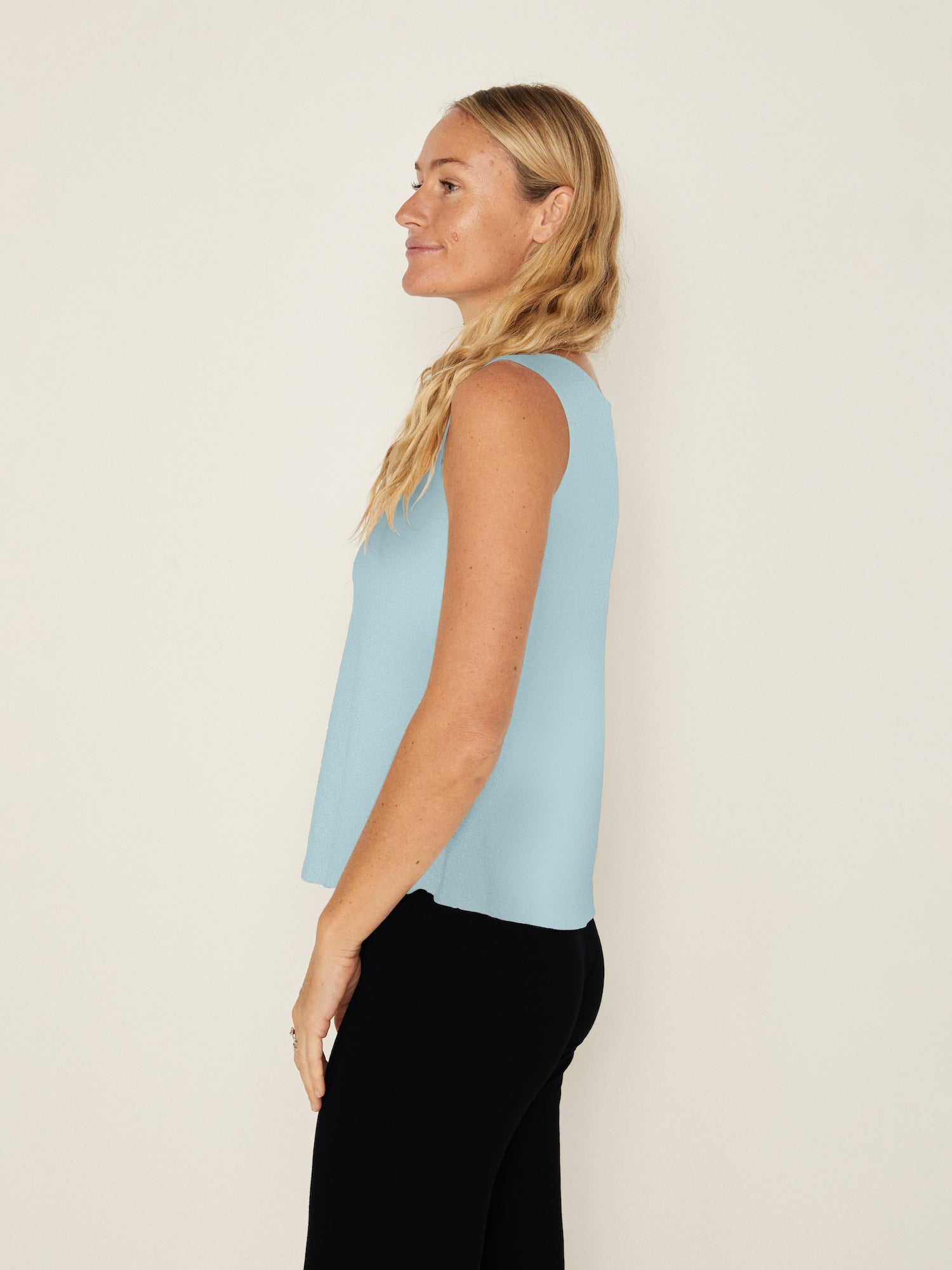 Woman wearing light Topaz blue boat neck singlet, women's bamboo clothing