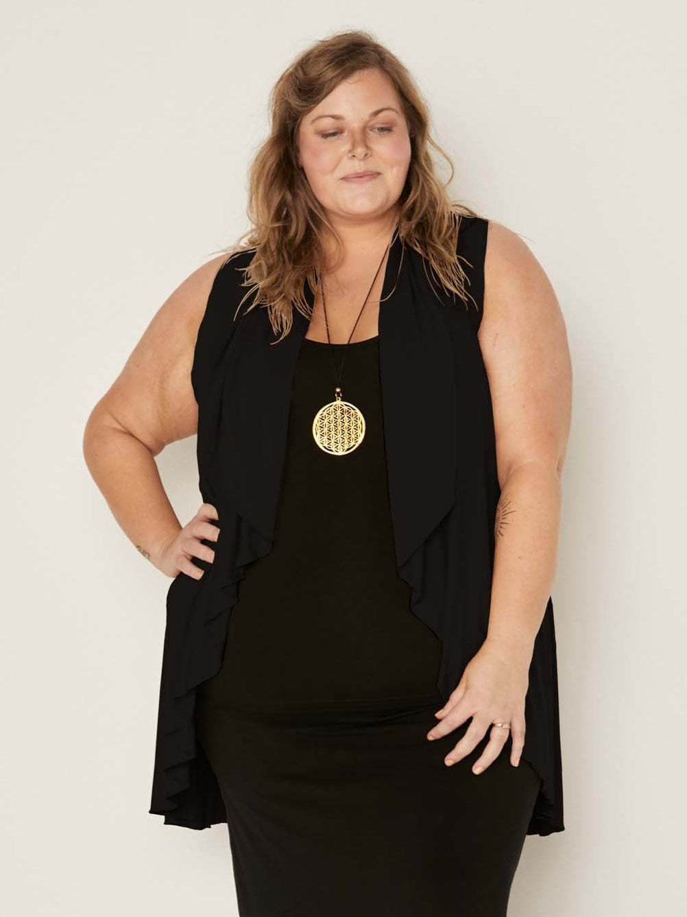 Model wearing a black convertible style goddess wrap; long cardi, vest or poncho, women's bamboo clothing
