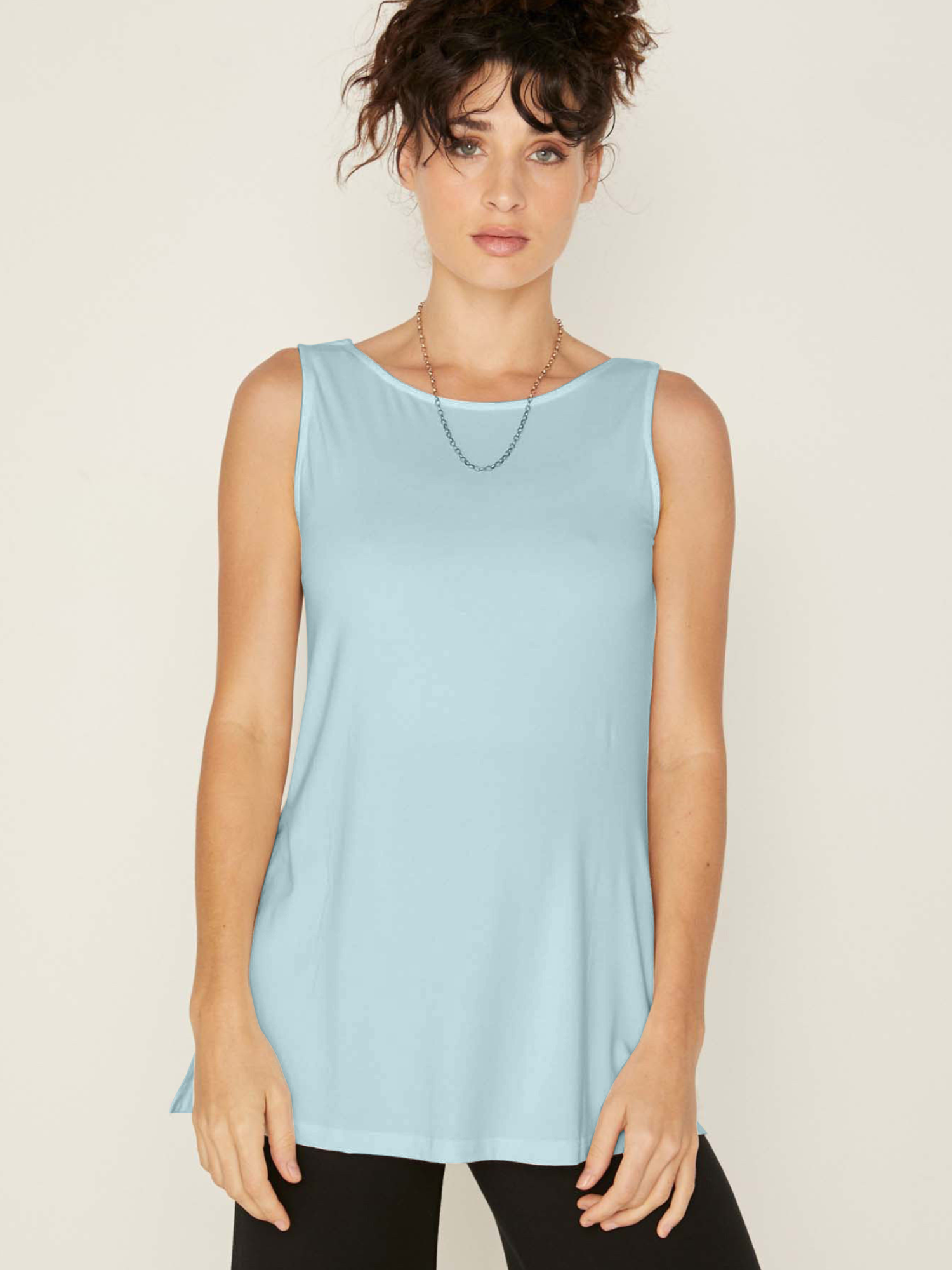 Model wearing a reversible topaz blue a-line singlet with scoop and boat necklines and long line body, women's bamboo clothing