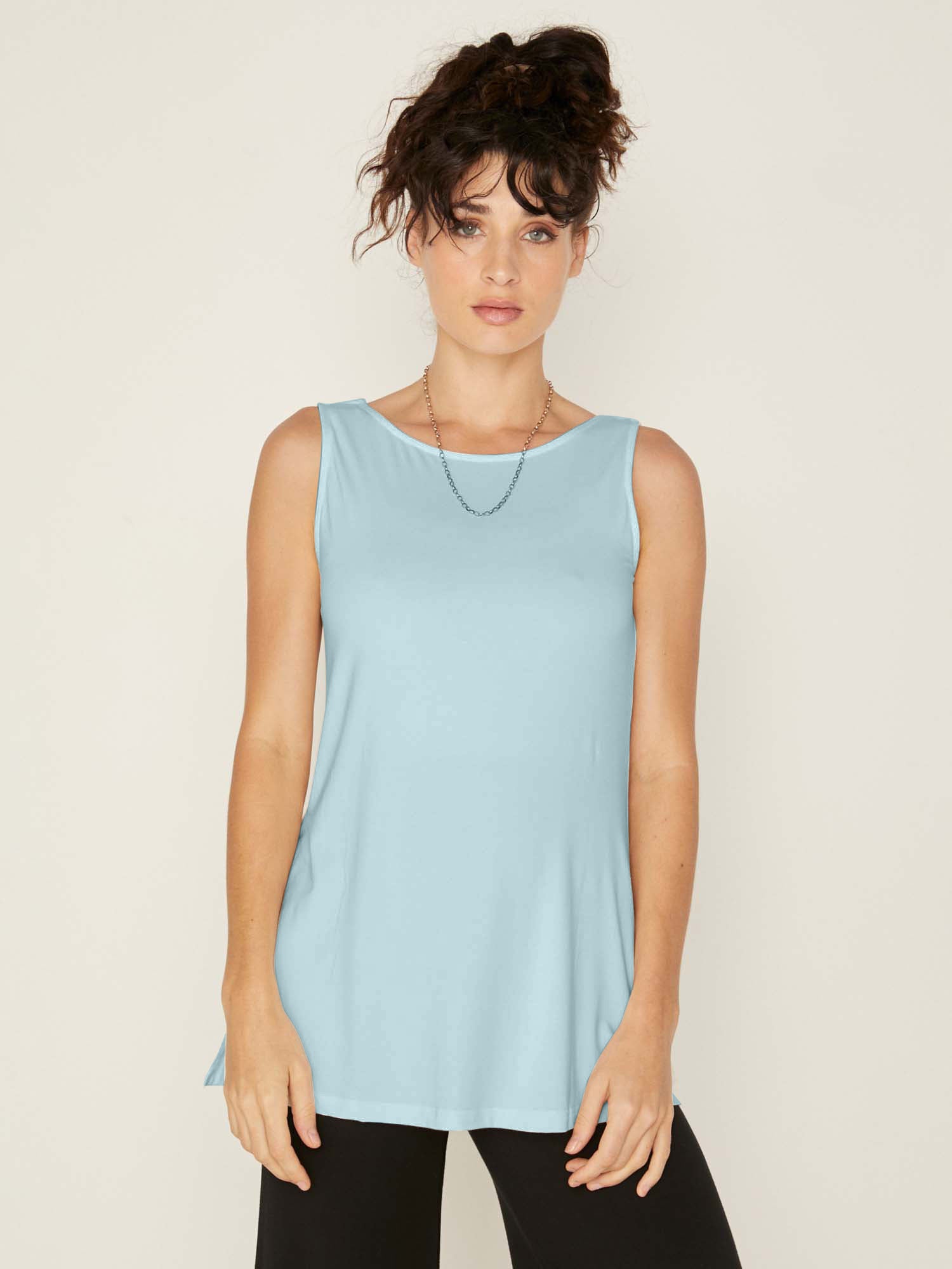 Woman wearing a bamboo, topaz light blue sleeveless top