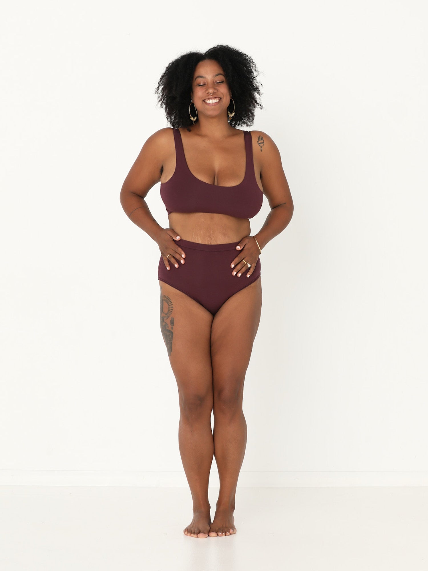 Woman wearing a burgundy reversible bra and full brief bamboo undies set on a white background, womens bamboo underwear