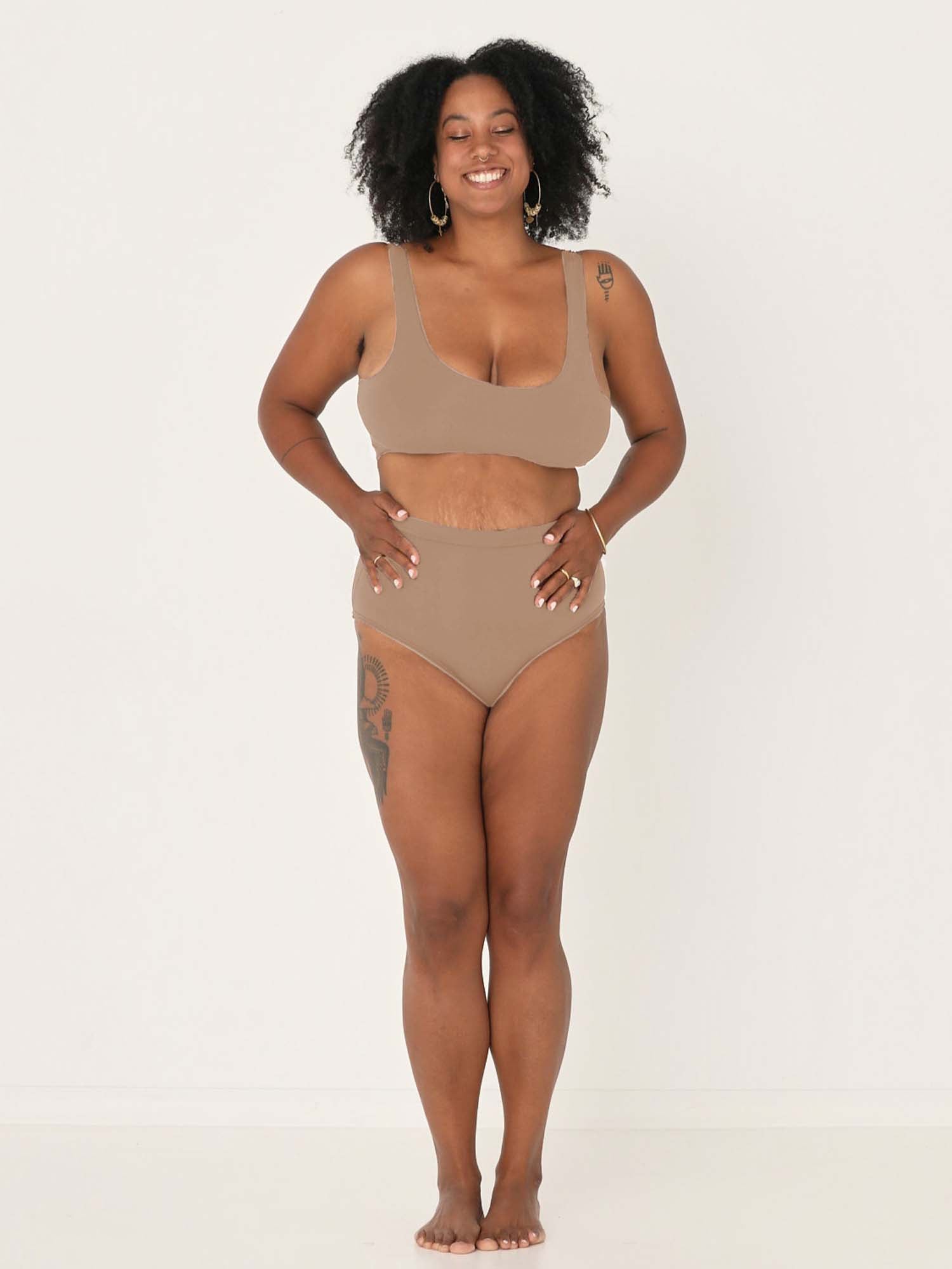 Model wearing caramel high waisted full brief with mid leg opening and double layered waistband, women's bamboo underwear