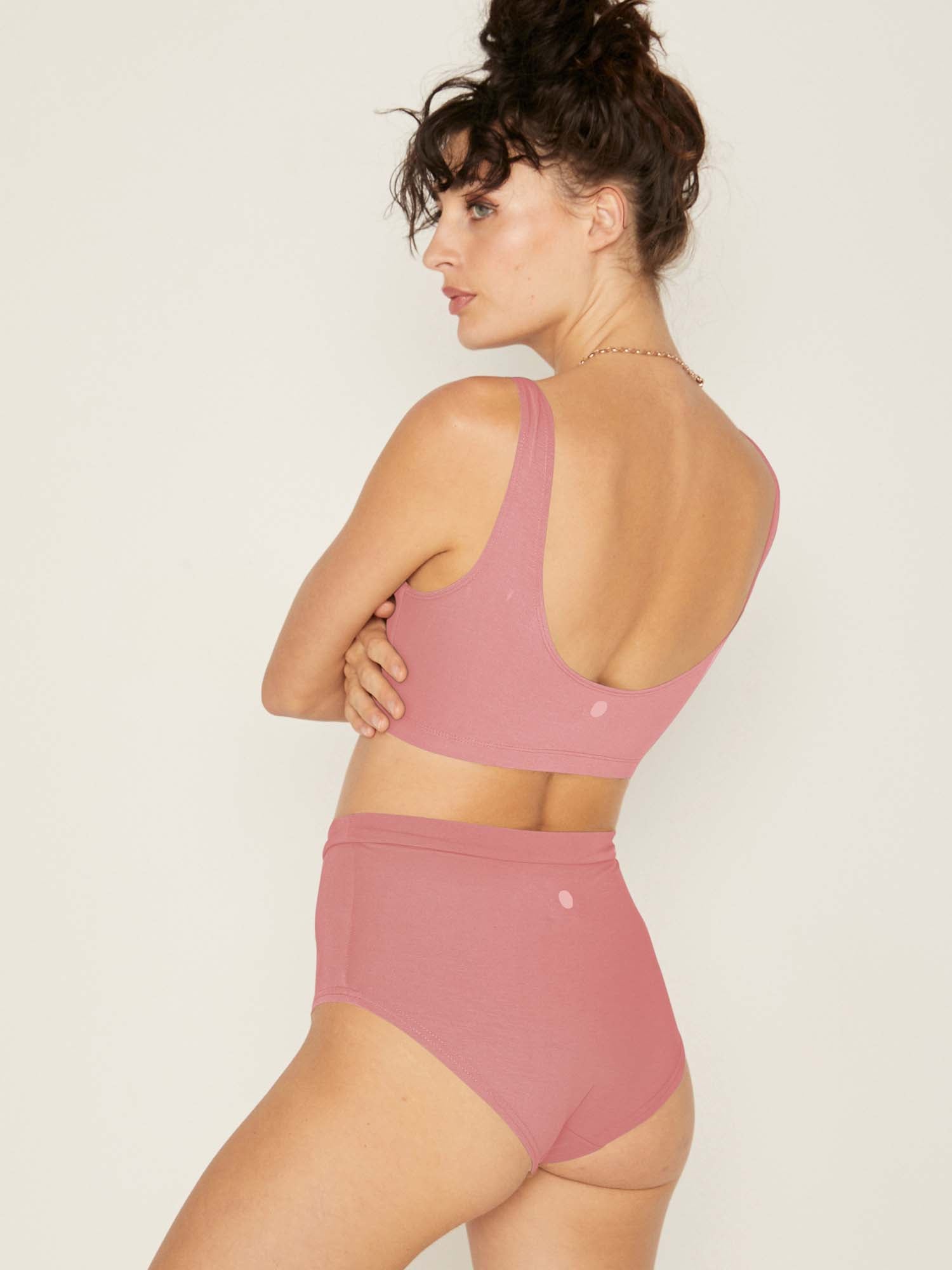 Model wearing pink clay high waisted full brief with mid leg opening and double layered waistband, women's bamboo underwear