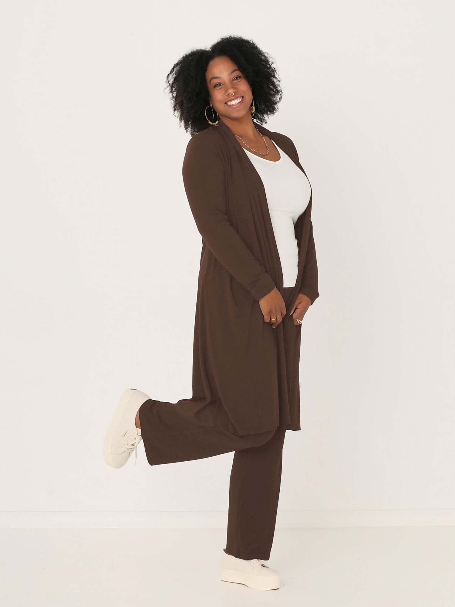 Model wearing cocoa brown long cardigan, below knee length jacket with long fitted sleeves, women's bamboo clothing