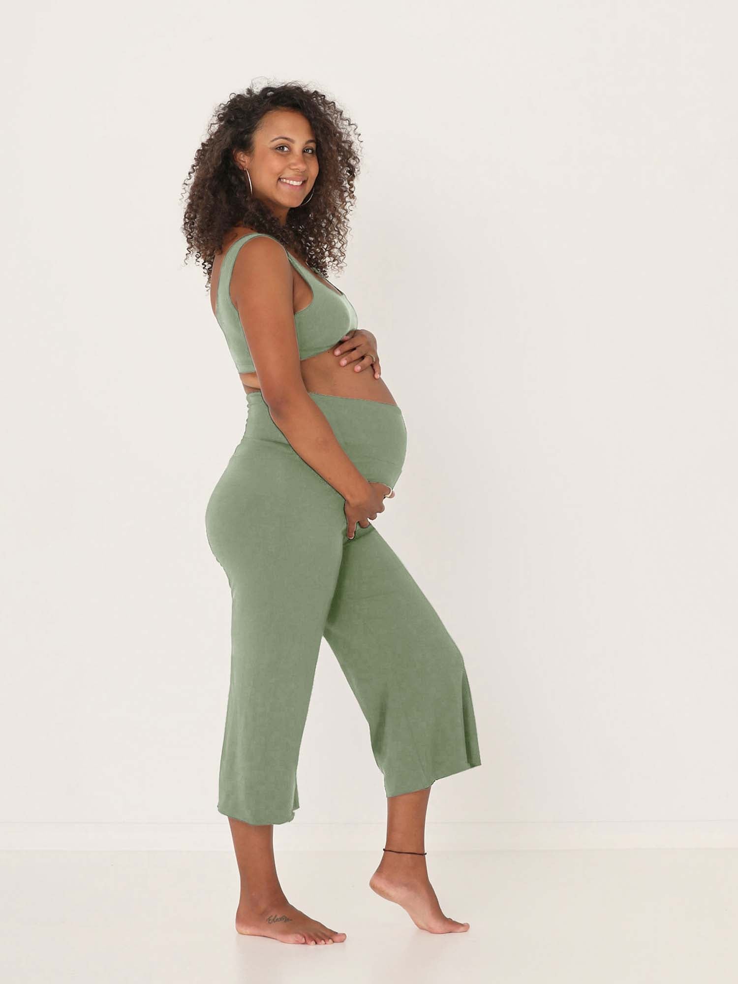 Model wearing eucalyptus green 7/8 length resort pants, double layered adjustible high waistband, classic design, women's bamboo clothing