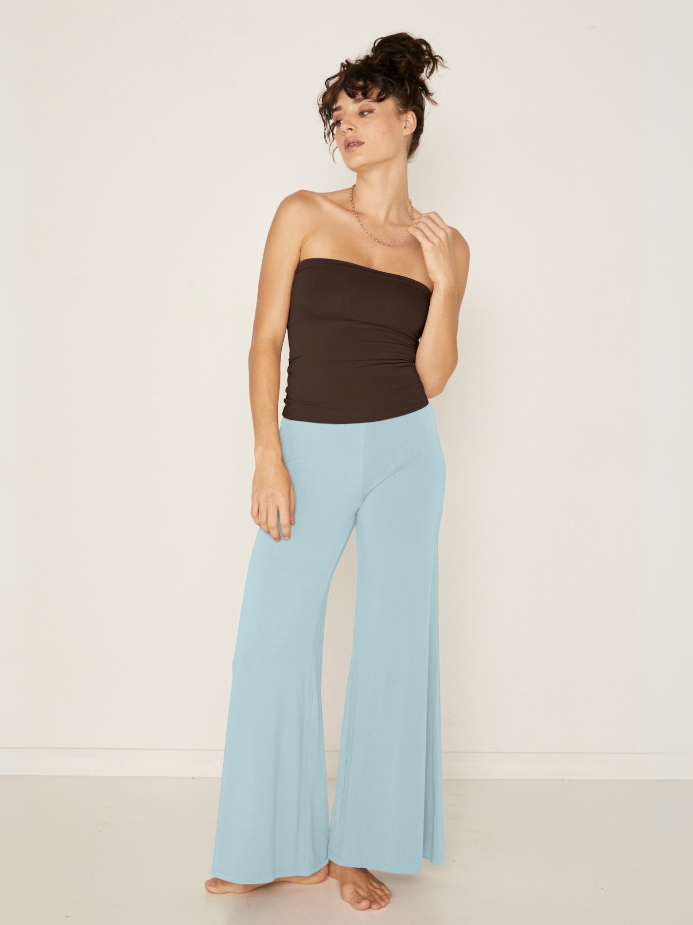 woman wearing a Bamboo light topaz blue wide leg palazzo pants with a cocoa brown tube top