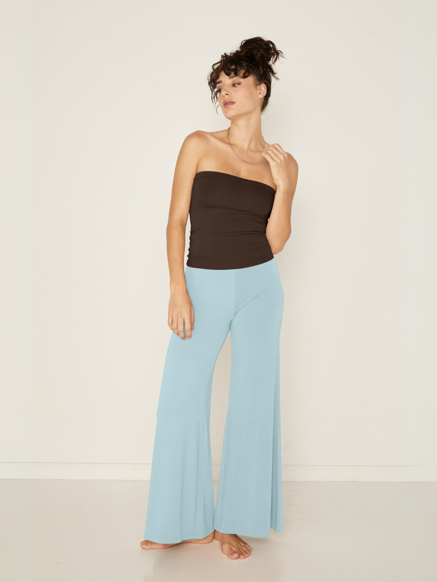 woman wearing a Bamboo light topaz blue wide leg palazzo pants with a cocoa brown tube top