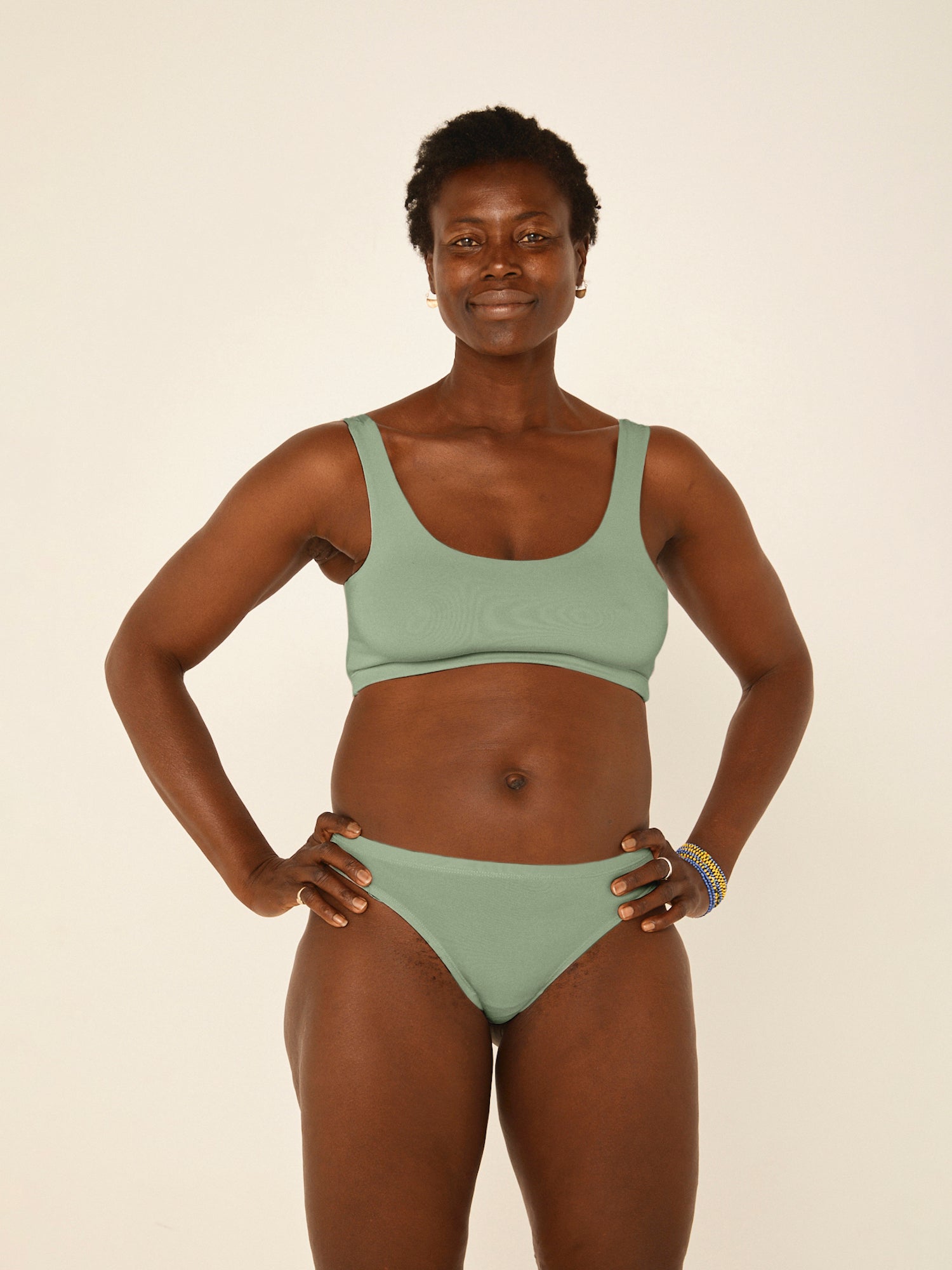 Model wearing eucalyptus green reversible bra, high or low scoop neckline and wide shoulder straps, wireless bra, women's bamboo underwear