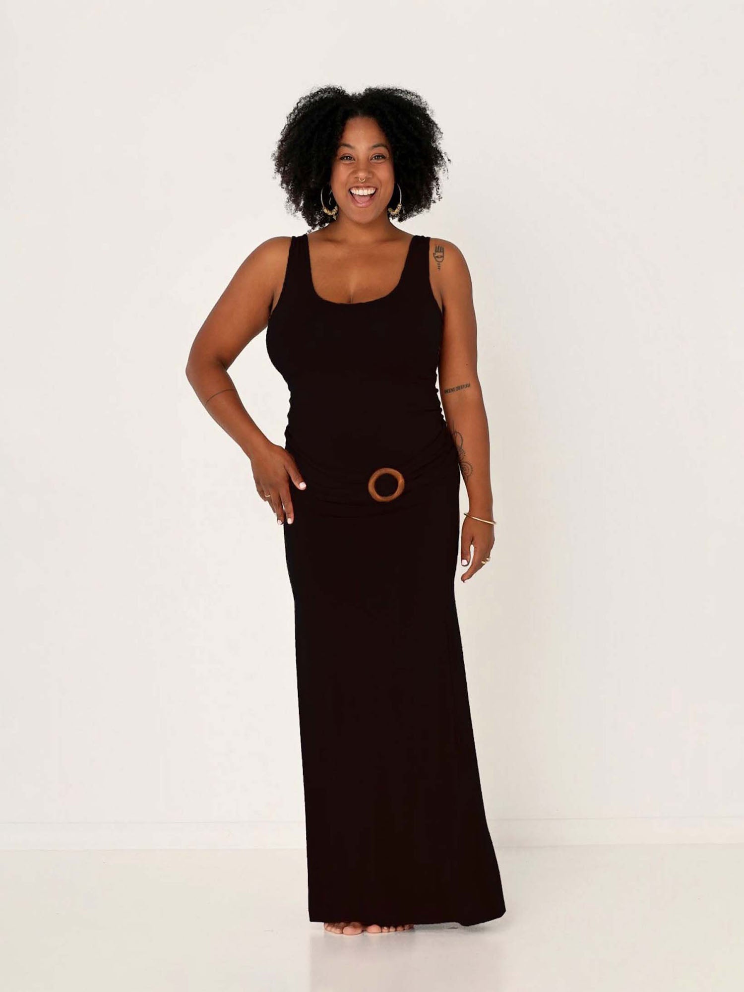 model wearing a long black maxi length skirt with classic singlet and belt, women's bamboo clothing